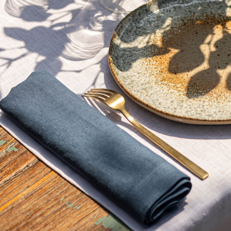 white linen table runner and blue linen napkins