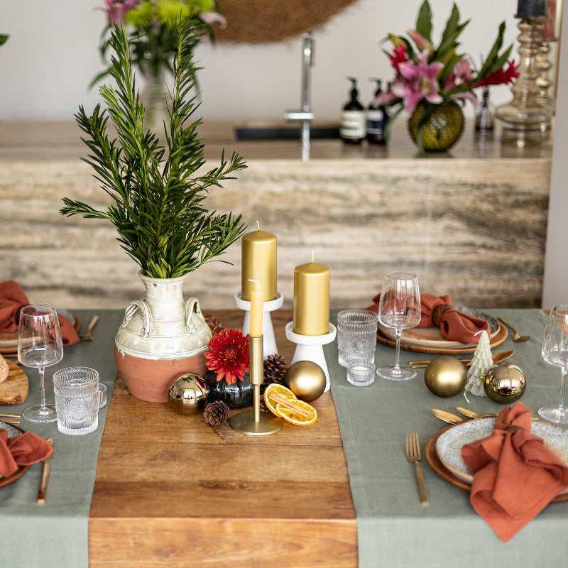 Olive green linen table runner with terracotta napkins