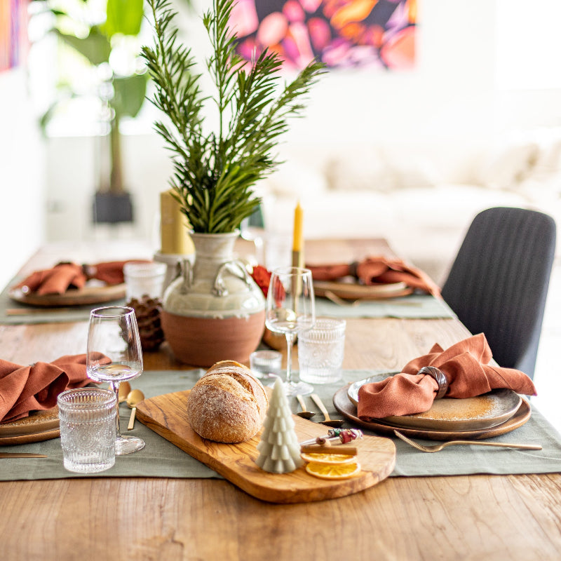 Olive green linen table runner with terracotta napkins