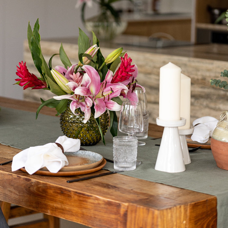 Olive green linen table runner with terracotta napkins