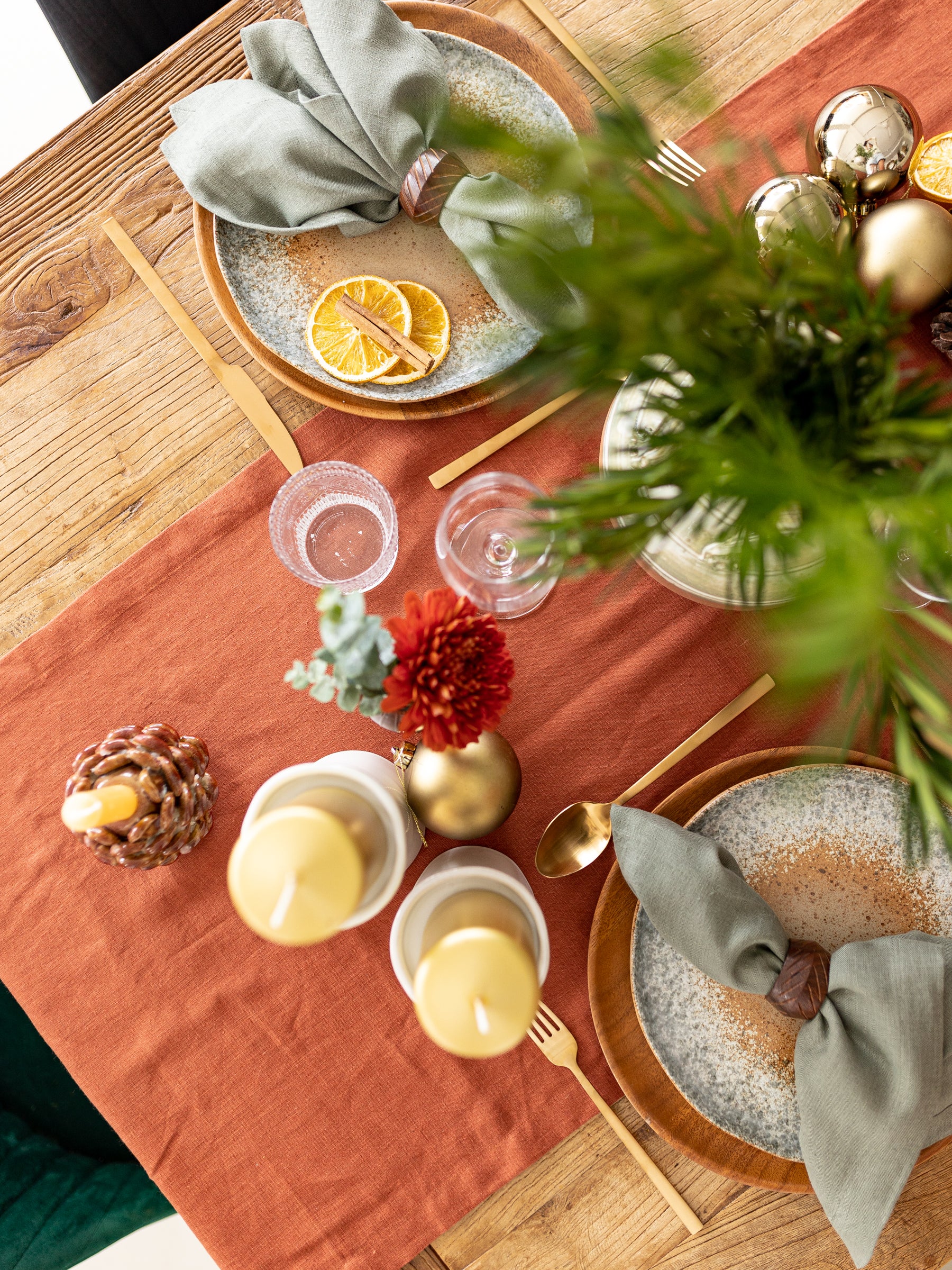 Terracotta linen table runner with green olive napkins 