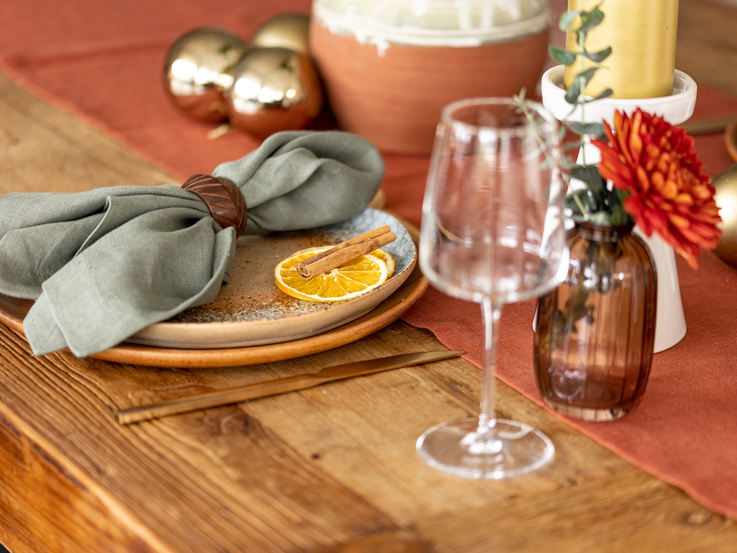 Terracotta linen table runner with green olive napkins 